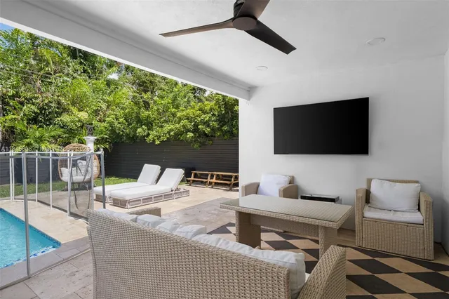 a outdoor living space with furniture and a flat screen tv