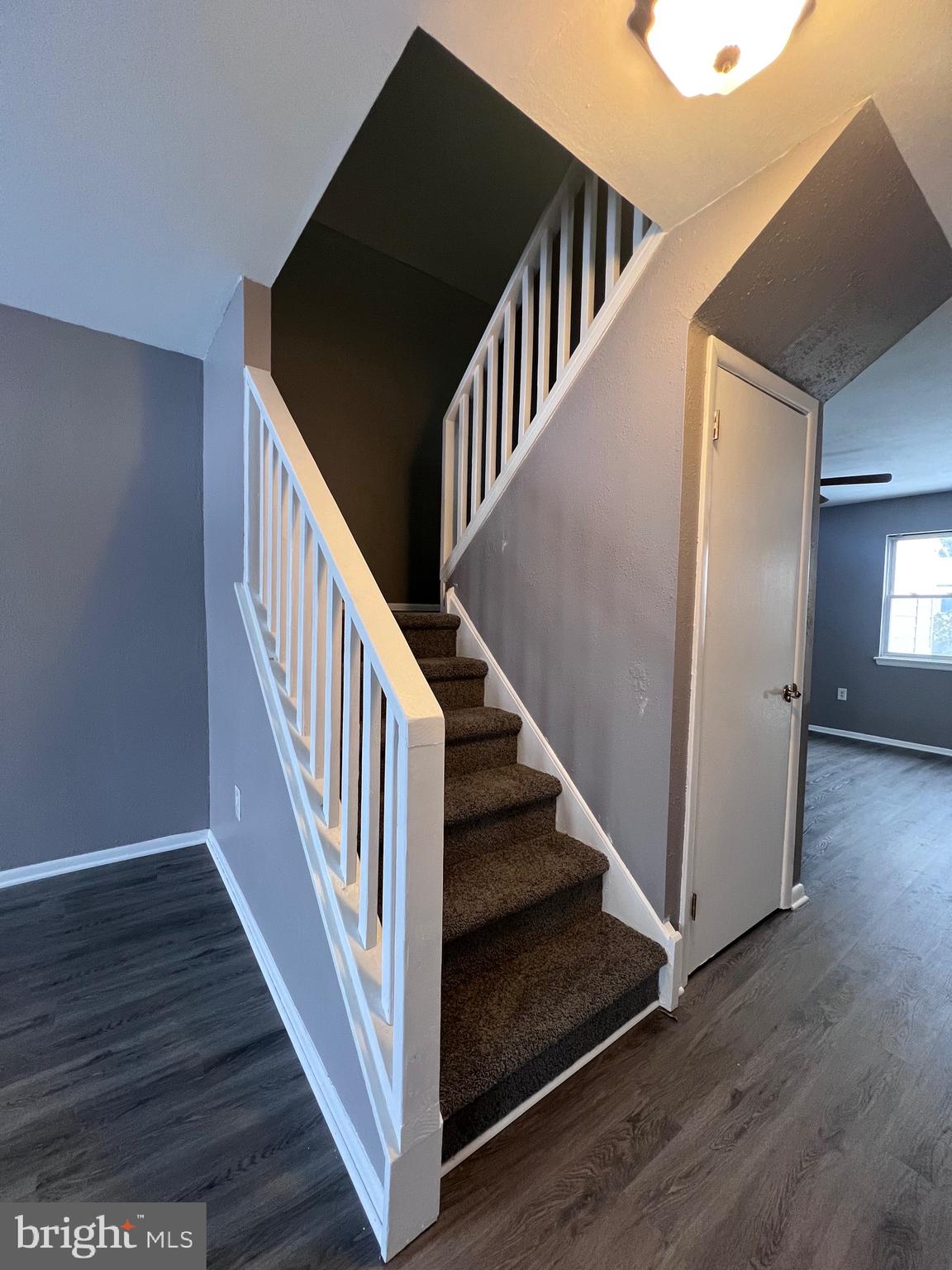 120 Hopkins Court Newark, DE 19713 - Photo 3 of 10 a view of staircase with wooden floor and white walls