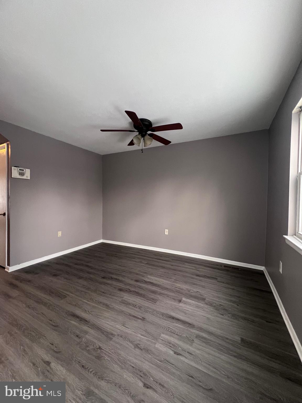 120 Hopkins Court Newark, DE 19713 - Photo 4 of 10 a view of an empty room with wooden floor and a window