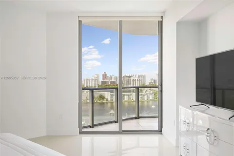 a bedroom with a large bed and a flat screen tv