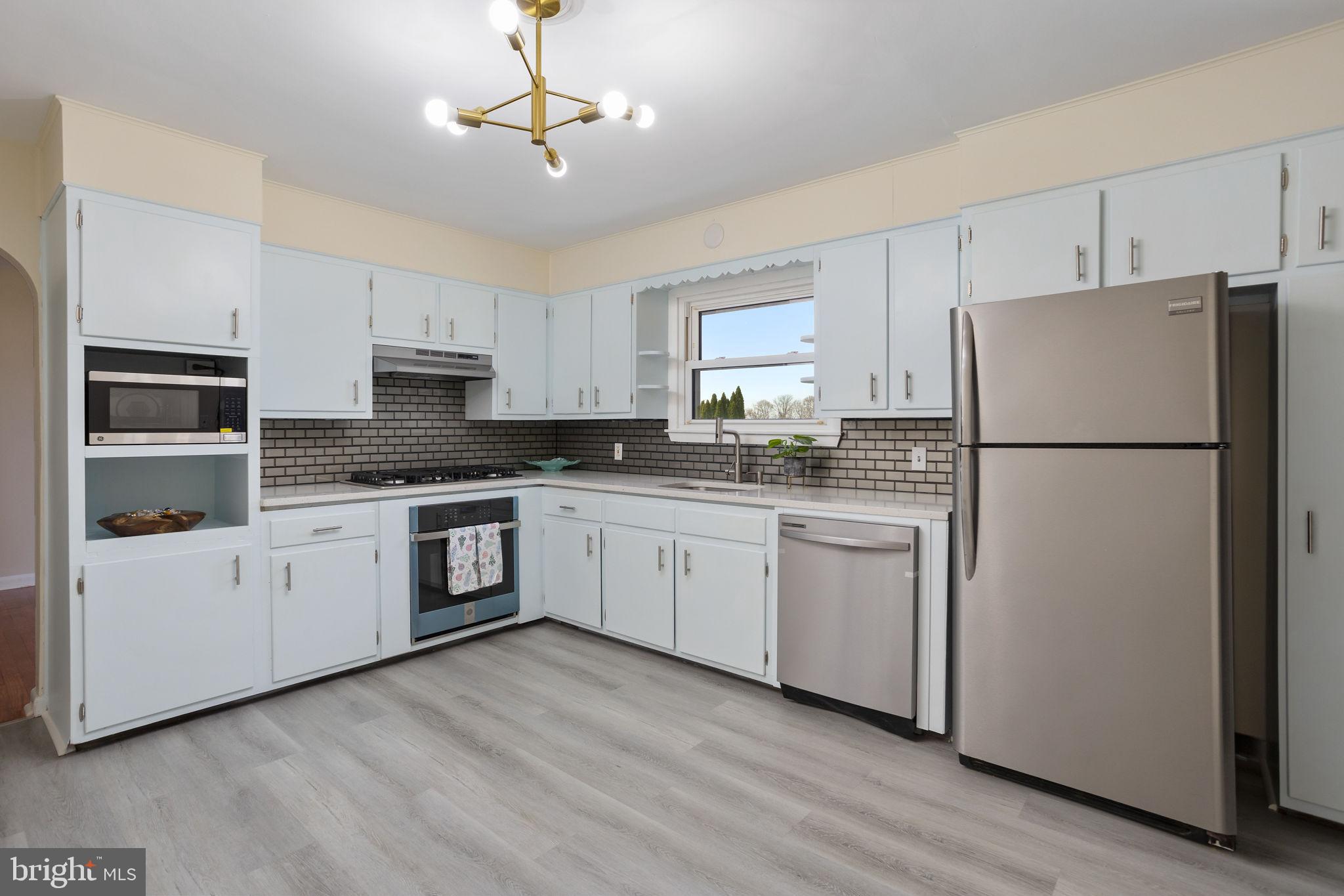 45 Cubberley Road West Windsor, NJ 08550 - Photo 11 of 37 a kitchen with a refrigerator a stove a microwave and cabinets