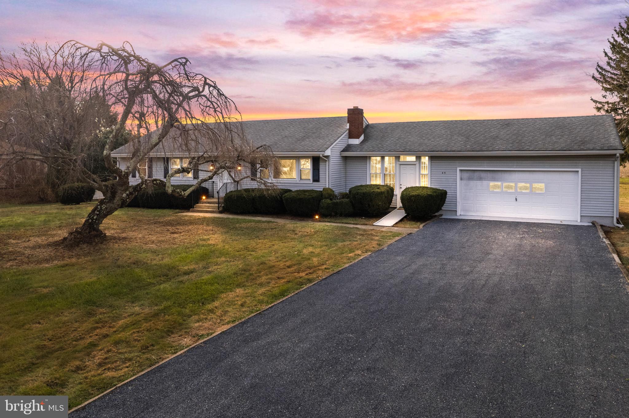 45 Cubberley Road West Windsor, NJ 08550 - Photo 3 of 37 a front view of a house with a yard and garage