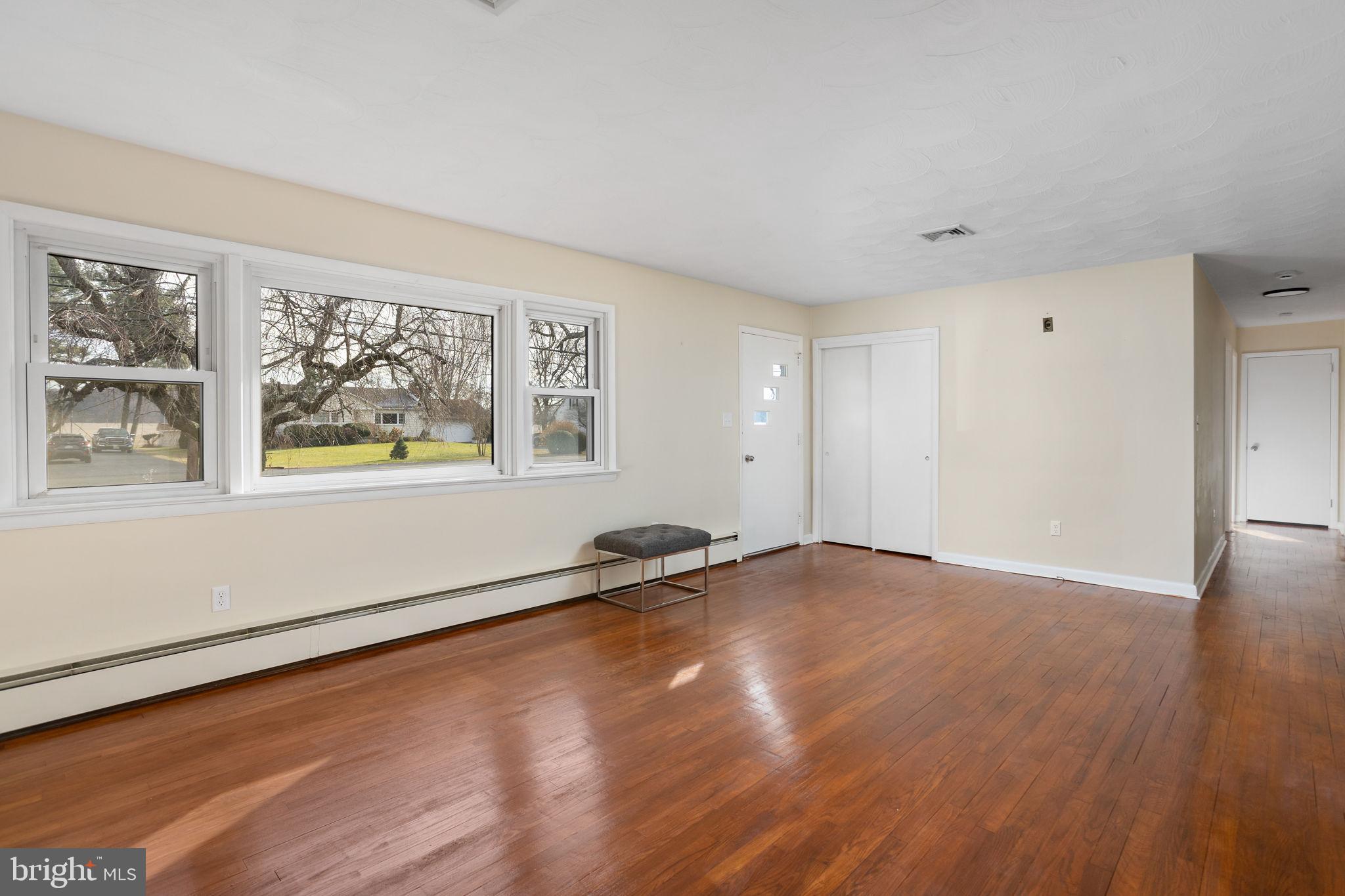 45 Cubberley Road West Windsor, NJ 08550 - Photo 6 of 37 a view of an empty room with wooden floor and a window