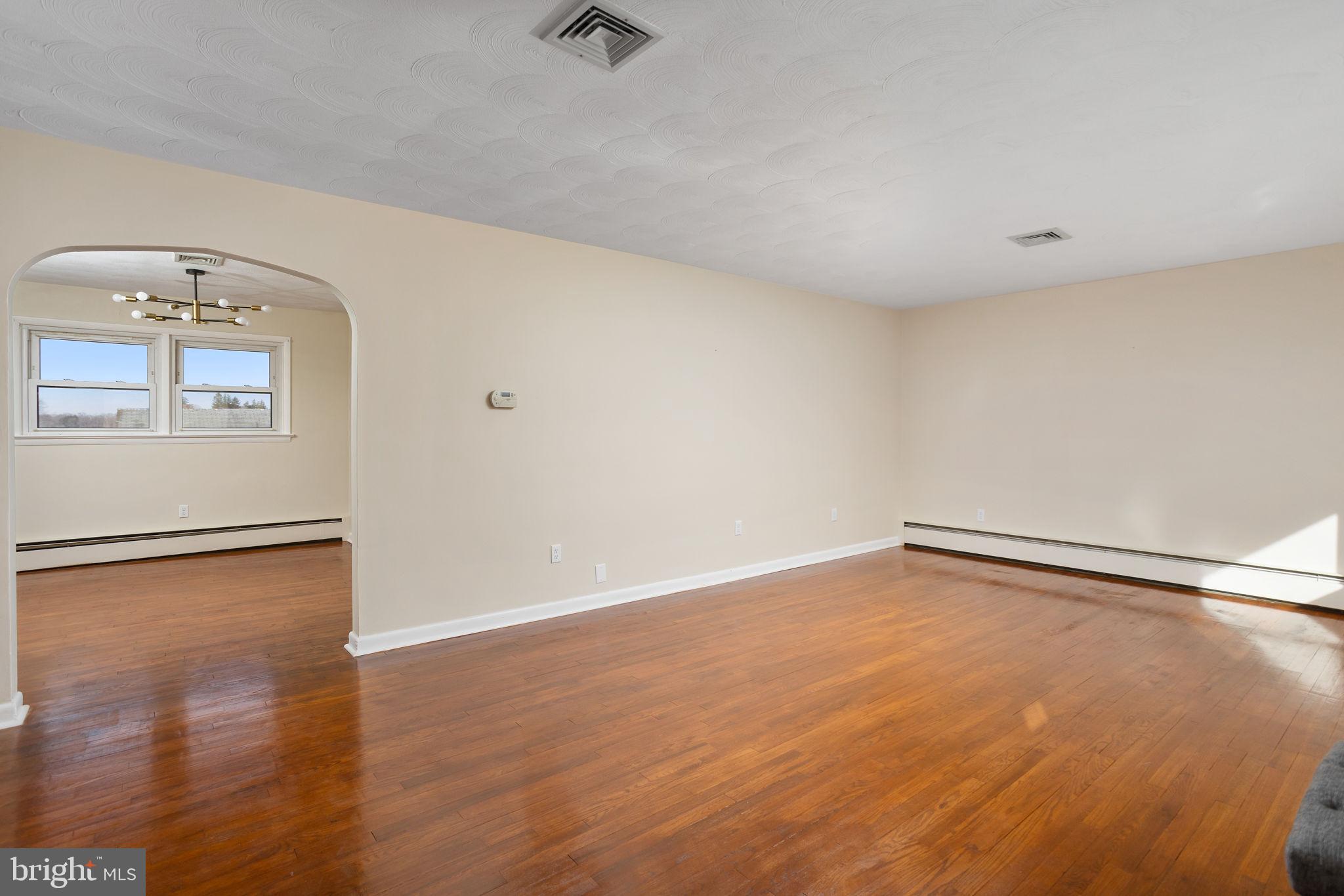 45 Cubberley Road West Windsor, NJ 08550 - Photo 7 of 37 a view of an empty room with wooden floor and a window