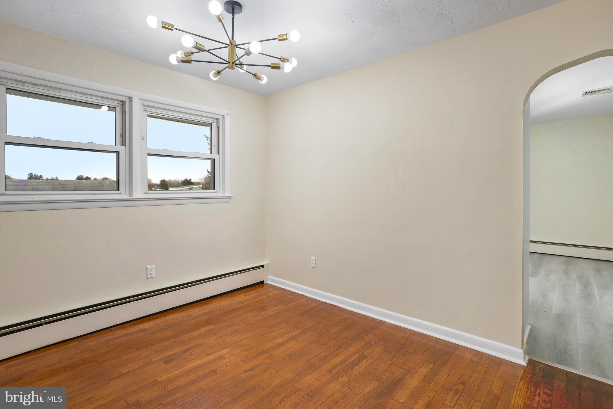 45 Cubberley Road West Windsor, NJ 08550 - Photo 8 of 37 an empty room with wooden floor fan and windows
