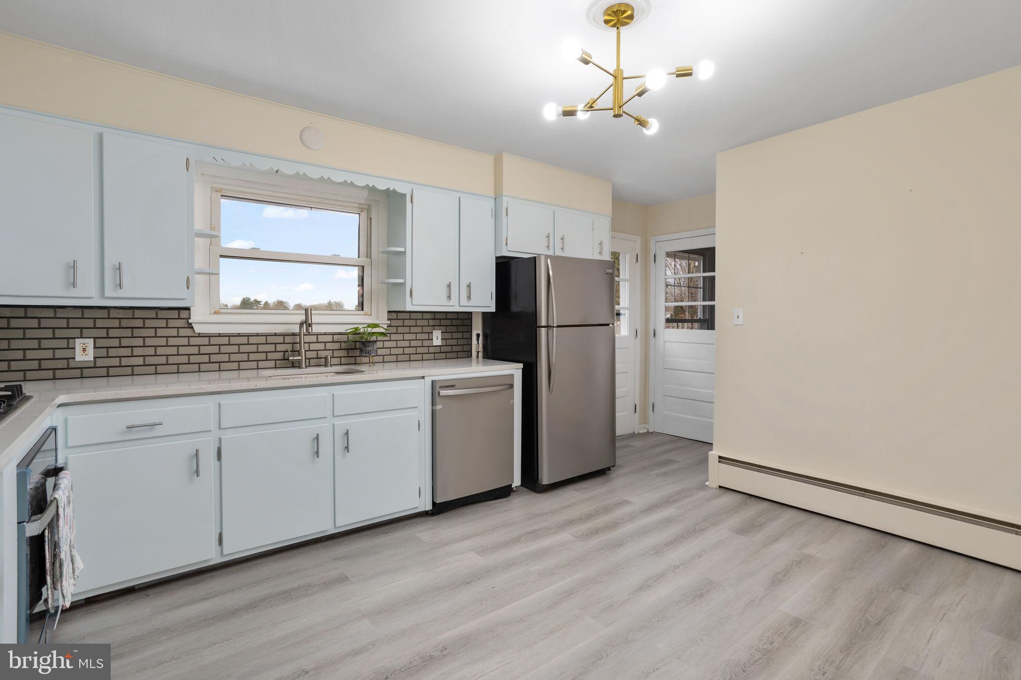 45 Cubberley Road West Windsor, NJ 08550 - Photo 10 of 37 a kitchen with a refrigerator a sink and dishwasher with wooden floor