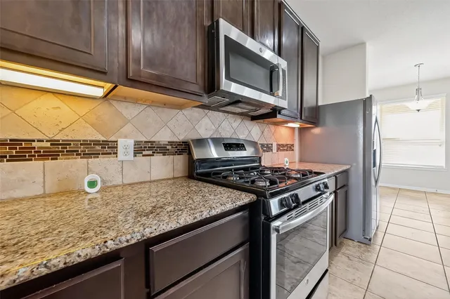a kitchen with a stove and a microwave