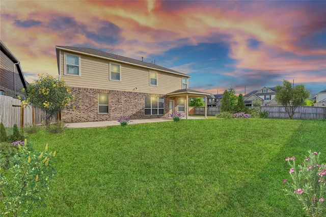 a front view of house with yard and green space
