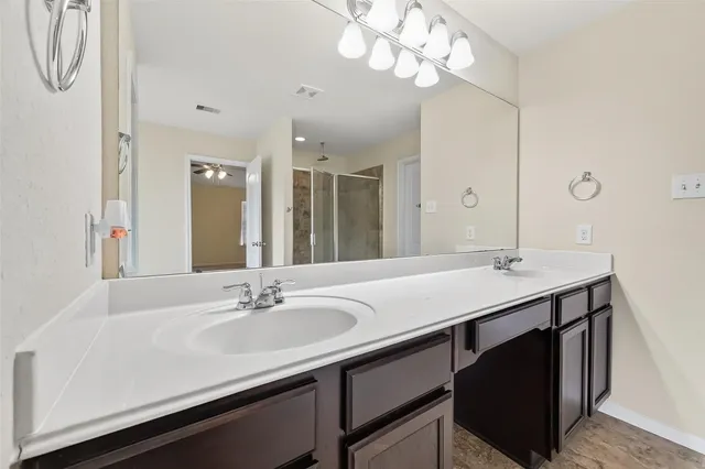 a bathroom with a sink double vanity and a mirror