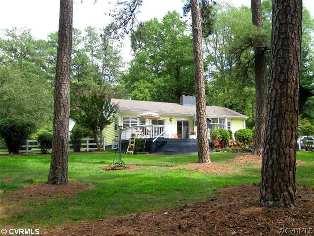 4406 Butte Road Richmond, VA 23235 - Photo 11 of 12 a view of a big yard with plants and large trees