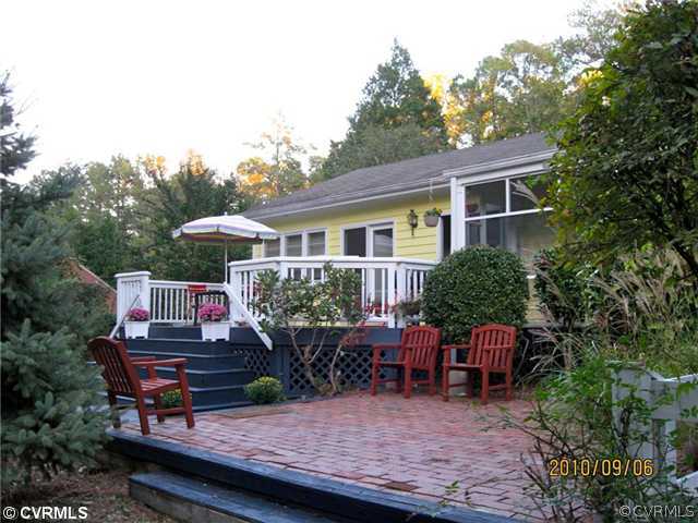 4406 Butte Road Richmond, VA 23235 - Photo 8 of 12 a wooden bench sitting in front of a house