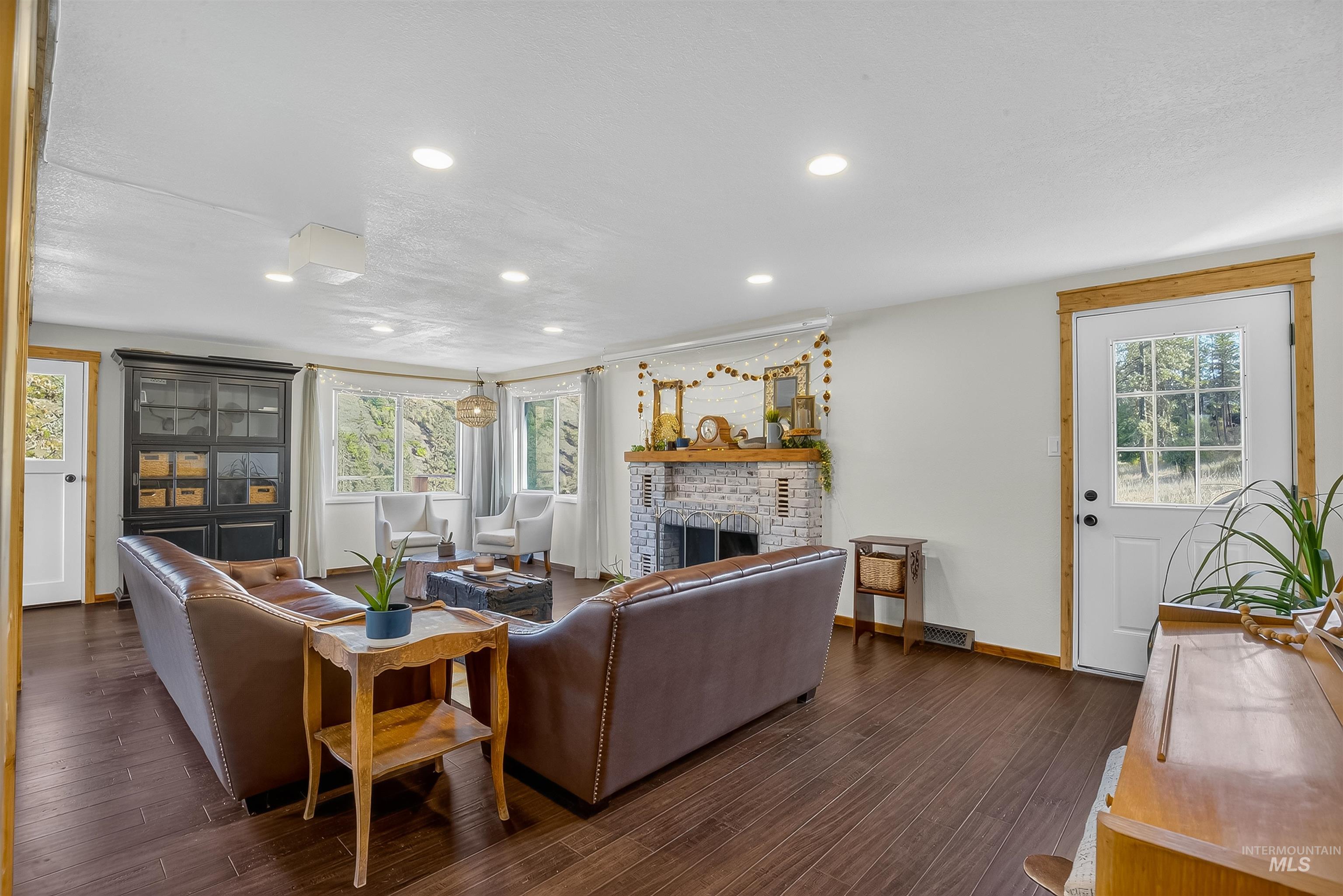 2157 Lukes Gulch Road Stites, ID 83552 - Photo 21 of 50 Living area featuring a brick fireplace, recessed lighting, and dark wood-style flooring