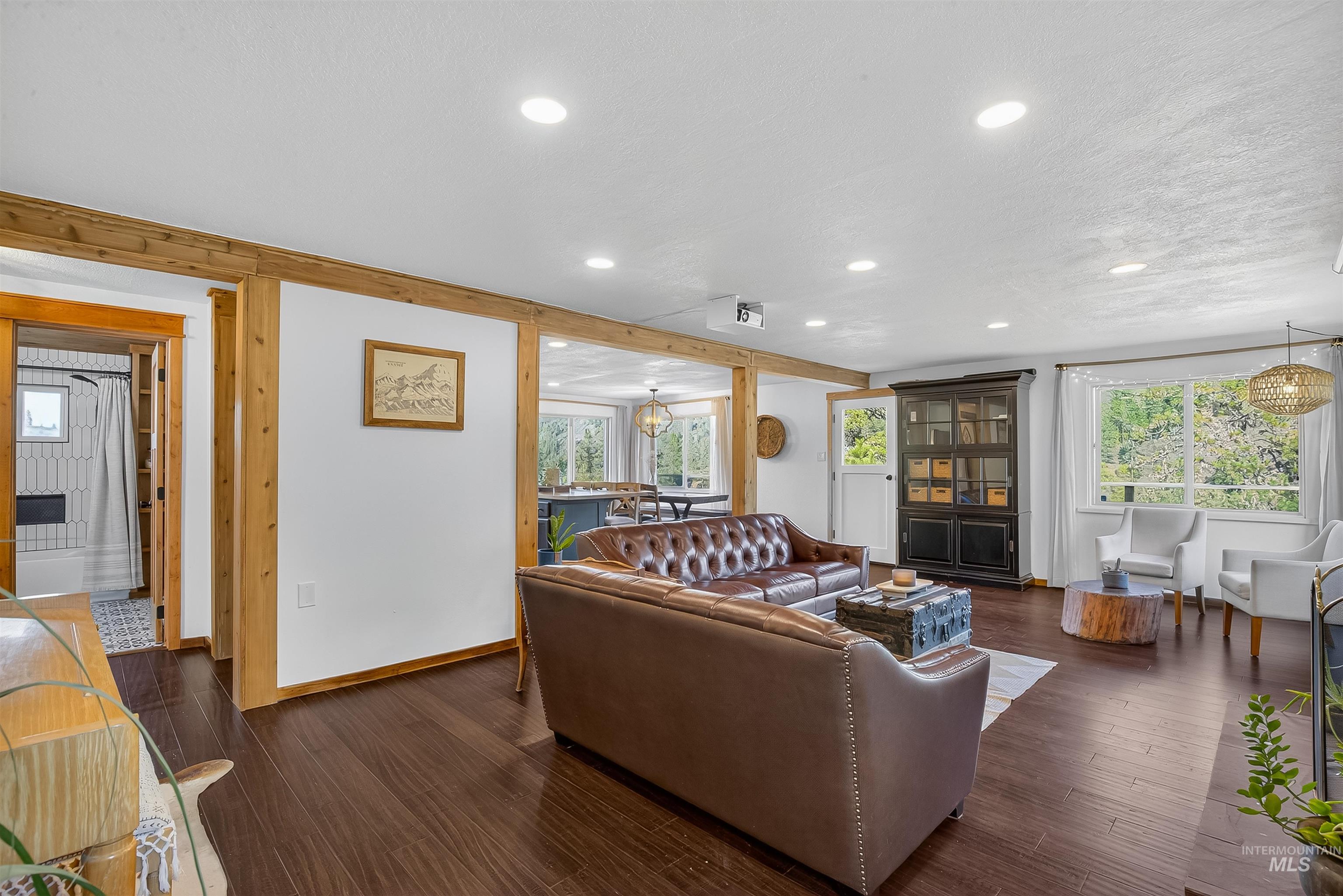2157 Lukes Gulch Road Stites, ID 83552 - Photo 22 of 50 Living area with a chandelier, plenty of natural light, dark wood-type flooring, and recessed lighting