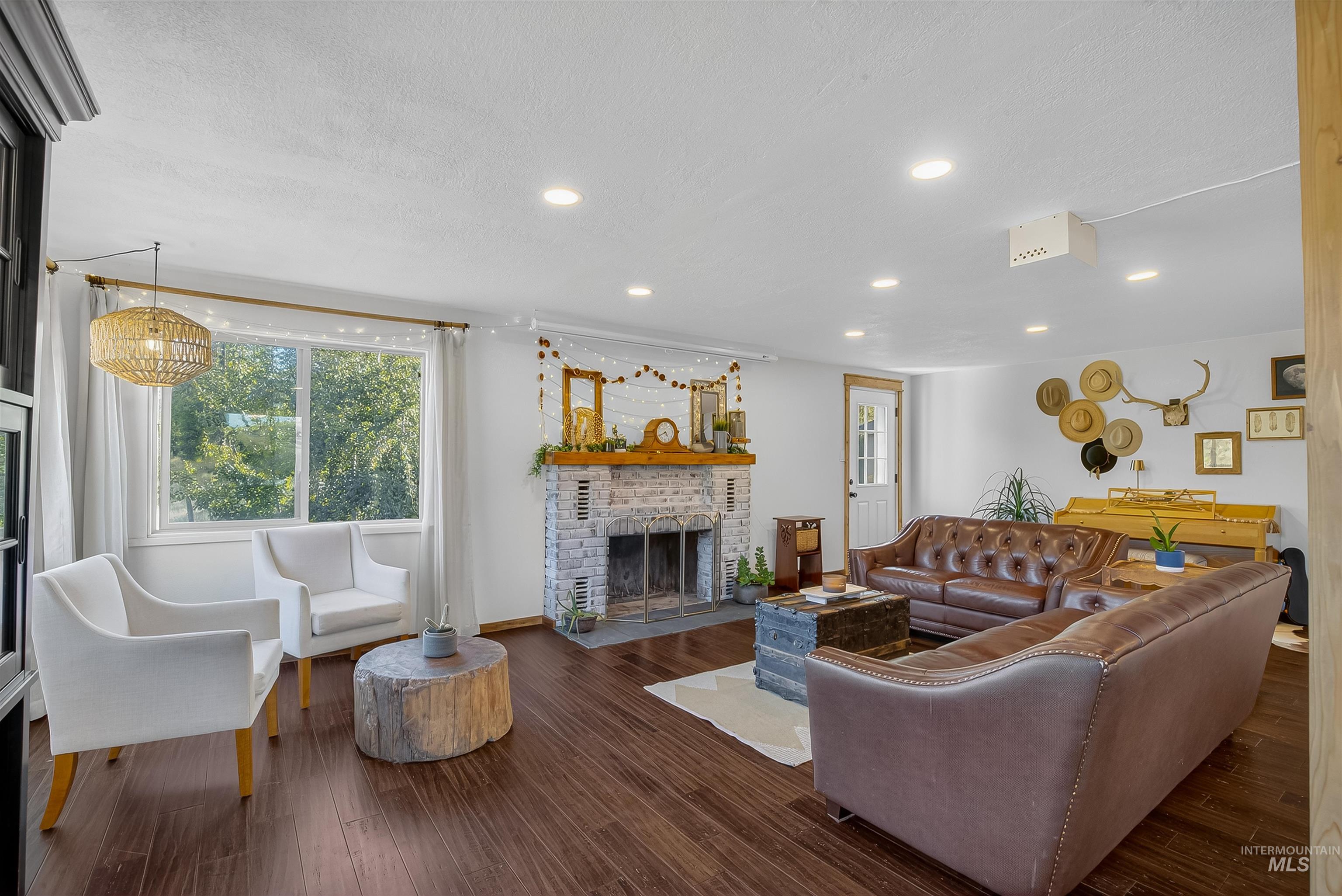 2157 Lukes Gulch Road Stites, ID 83552 - Photo 25 of 50 Living area with a brick fireplace, healthy amount of natural light, dark wood finished floors, and recessed lighting