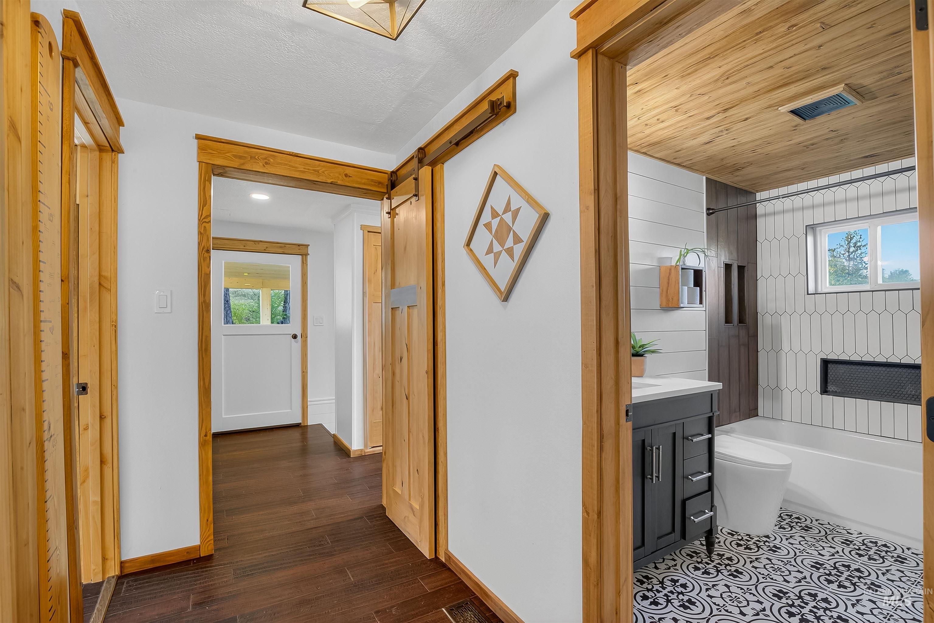 2157 Lukes Gulch Road Stites, ID 83552 - Photo 28 of 50 Corridor featuring a barn door and dark wood-type flooring