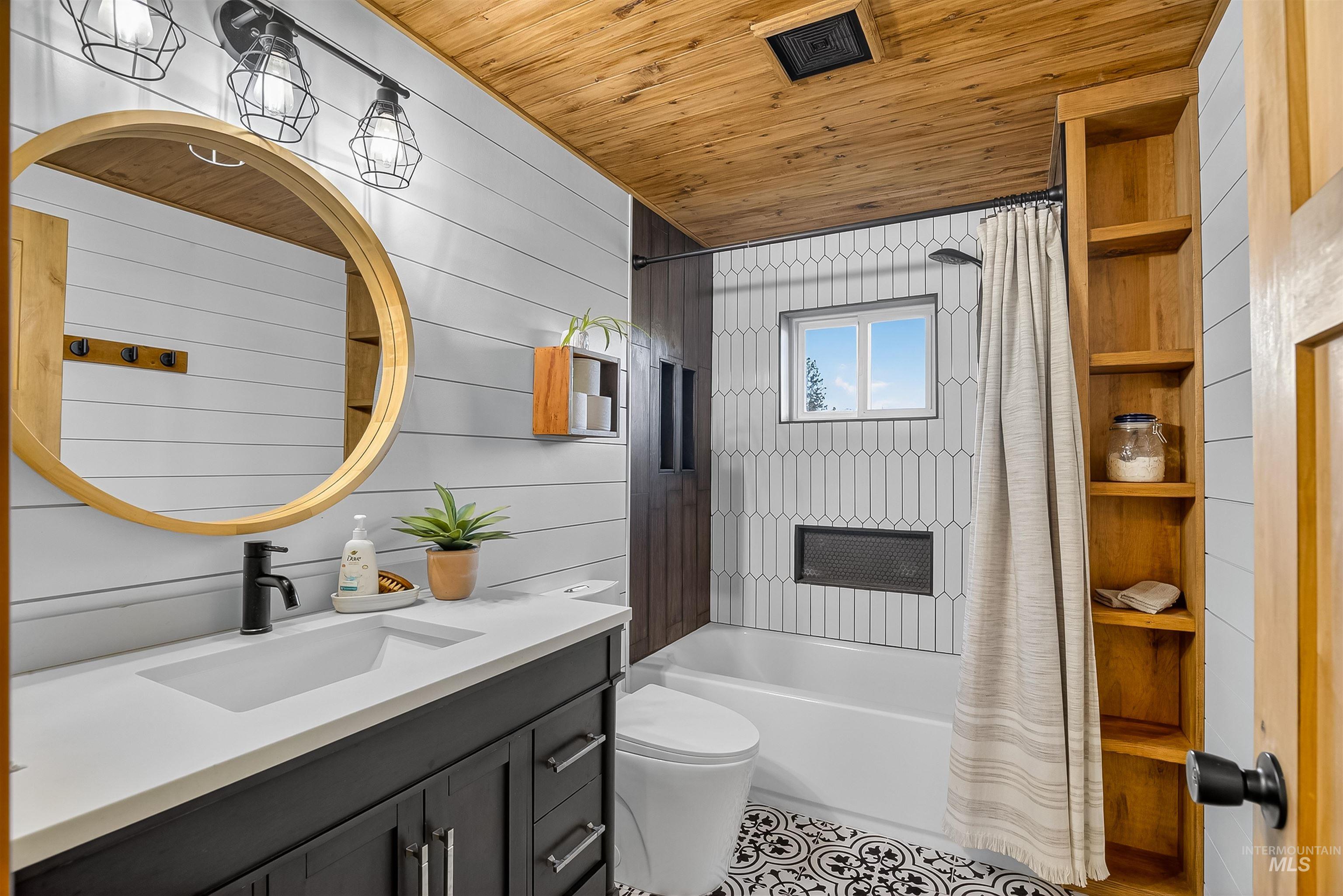 2157 Lukes Gulch Road Stites, ID 83552 - Photo 29 of 50 Bathroom with wood ceiling, shower / bathtub combination with curtain, vanity, and wood walls
