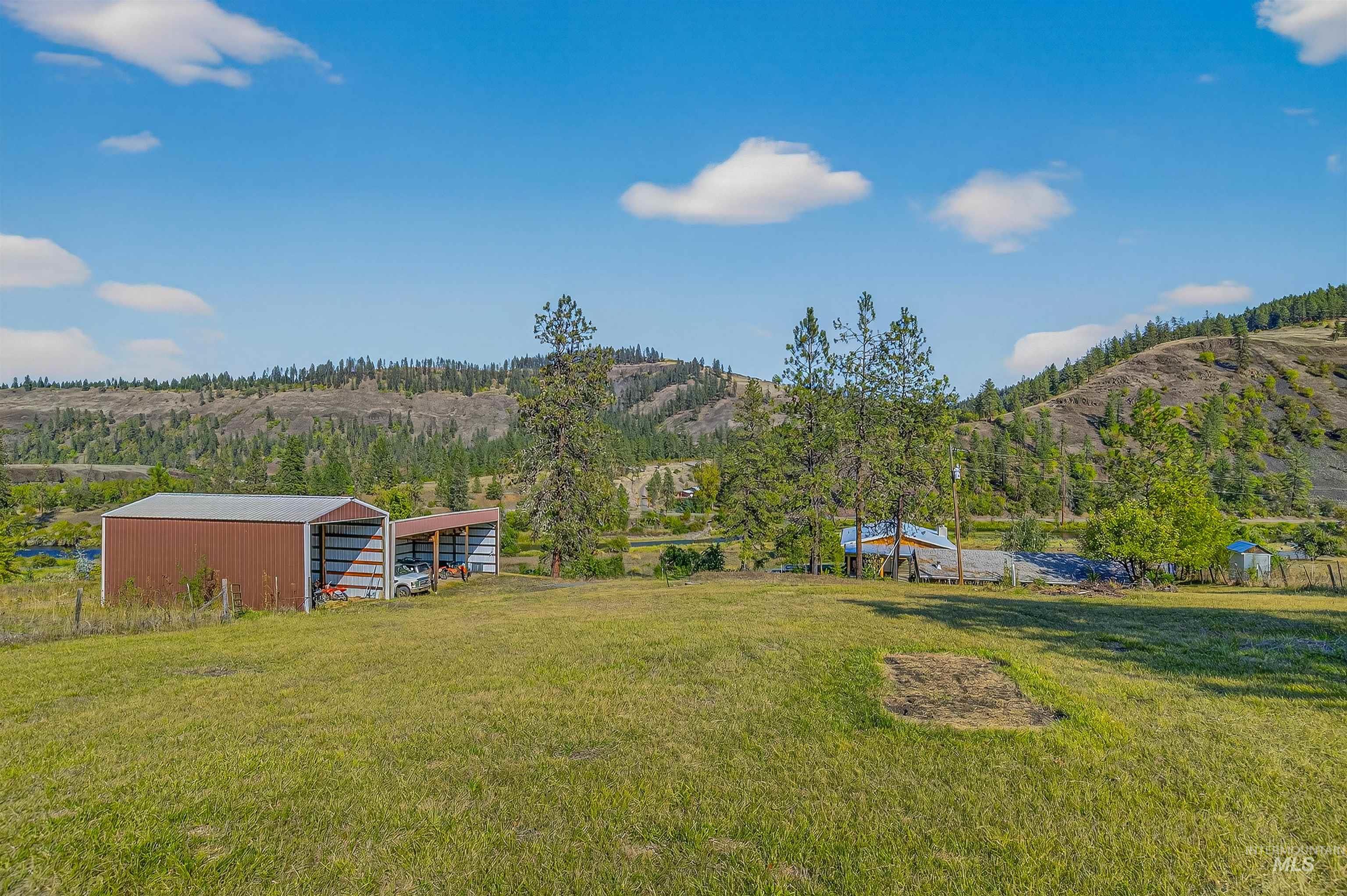2157 Lukes Gulch Road Stites, ID 83552 - Photo 46 of 50 View of grassy yard with an outbuilding, a view of countryside, a mountain view, and an outdoor structure