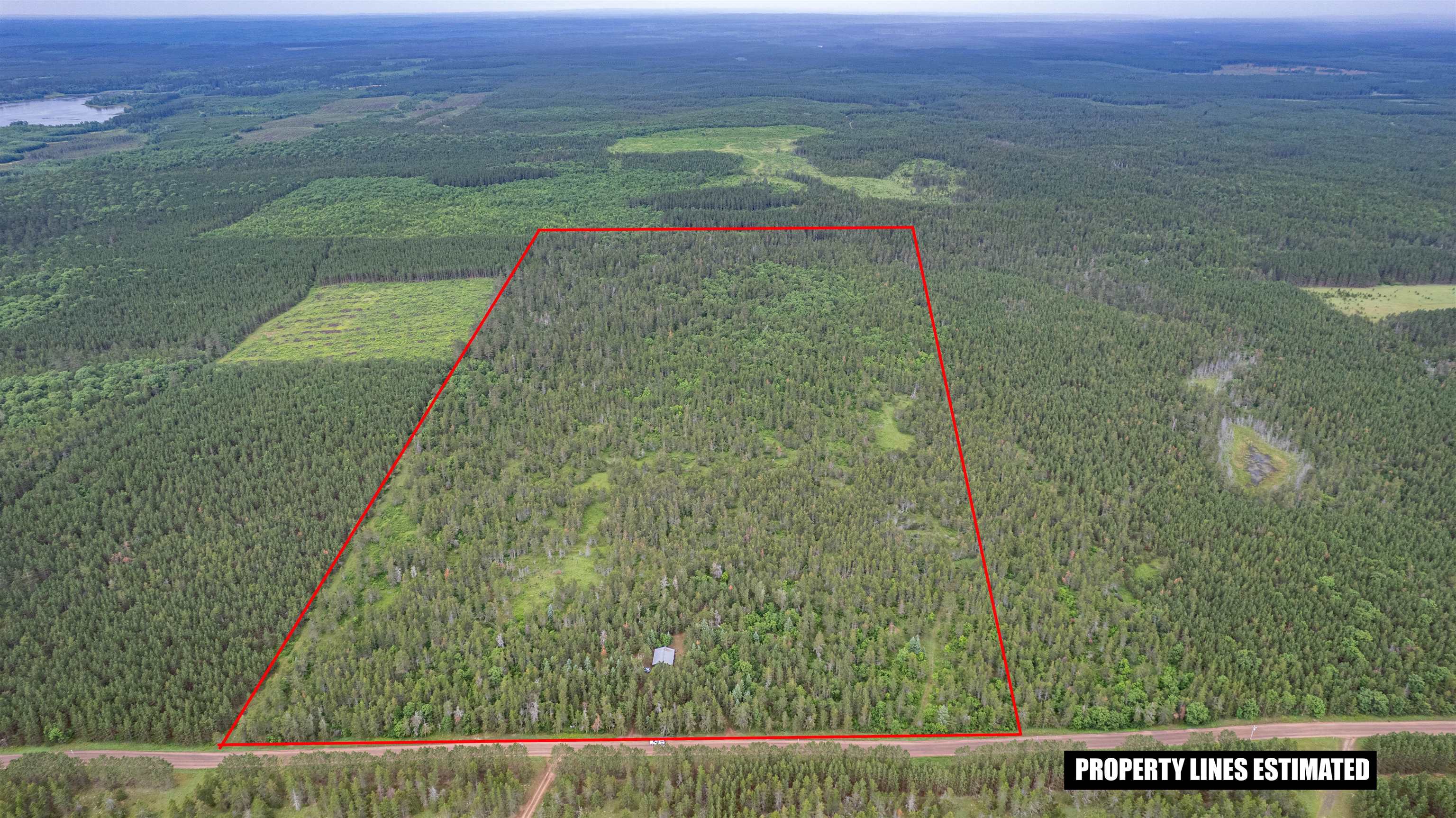 11321 East Town Line Road Solon Springs, WI 54873 - Photo 2 of 31 Aerial view of property and surrounding area with a forest and property parcel outlined