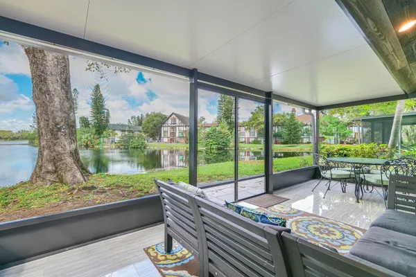 a room with pool table and chairs