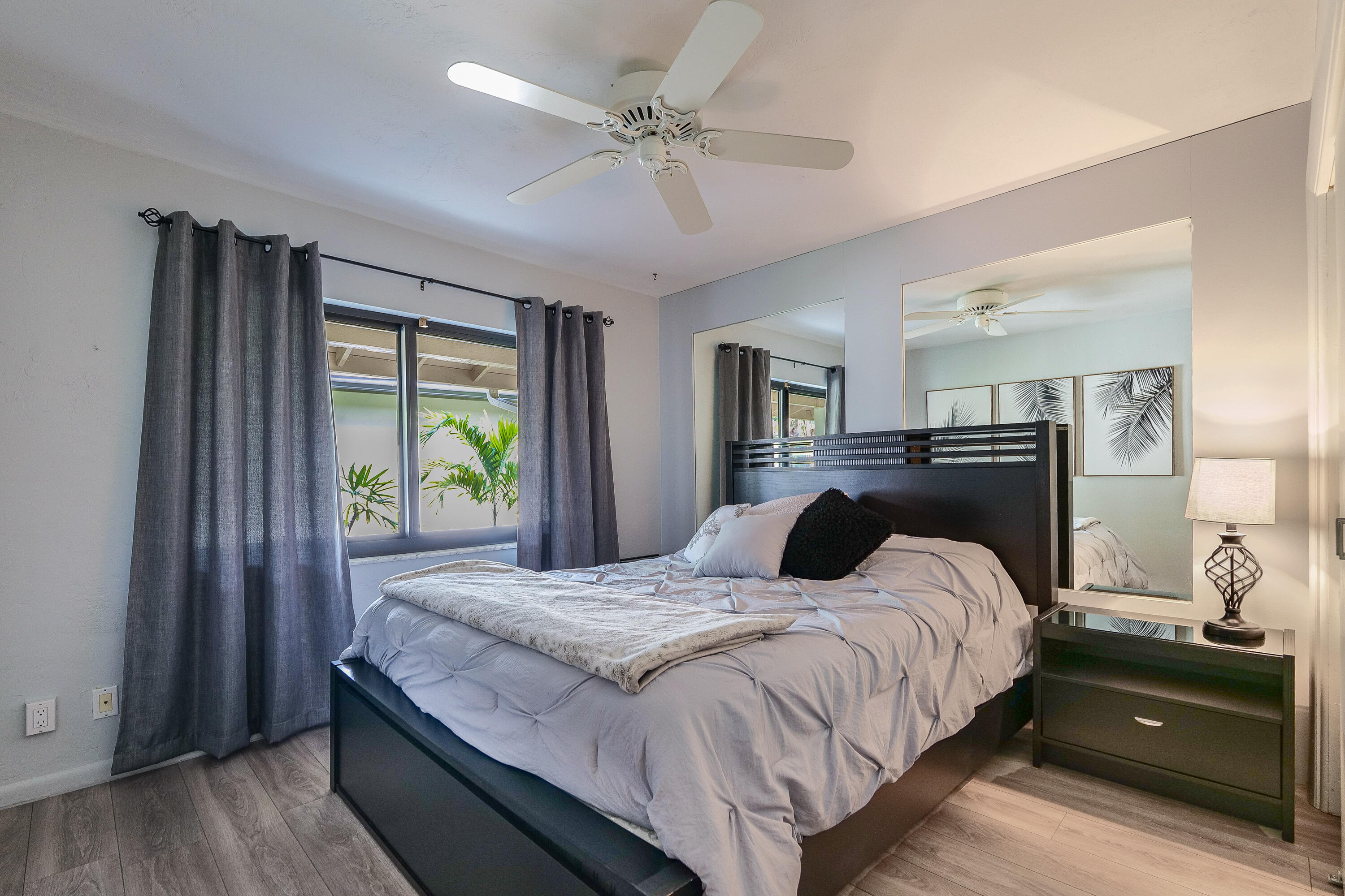 5535 Constant Spring Terrace, Unit 216 Lauderhill, FL 33319 - Photo 15 of 51 a bedroom with a bed and a chandelier