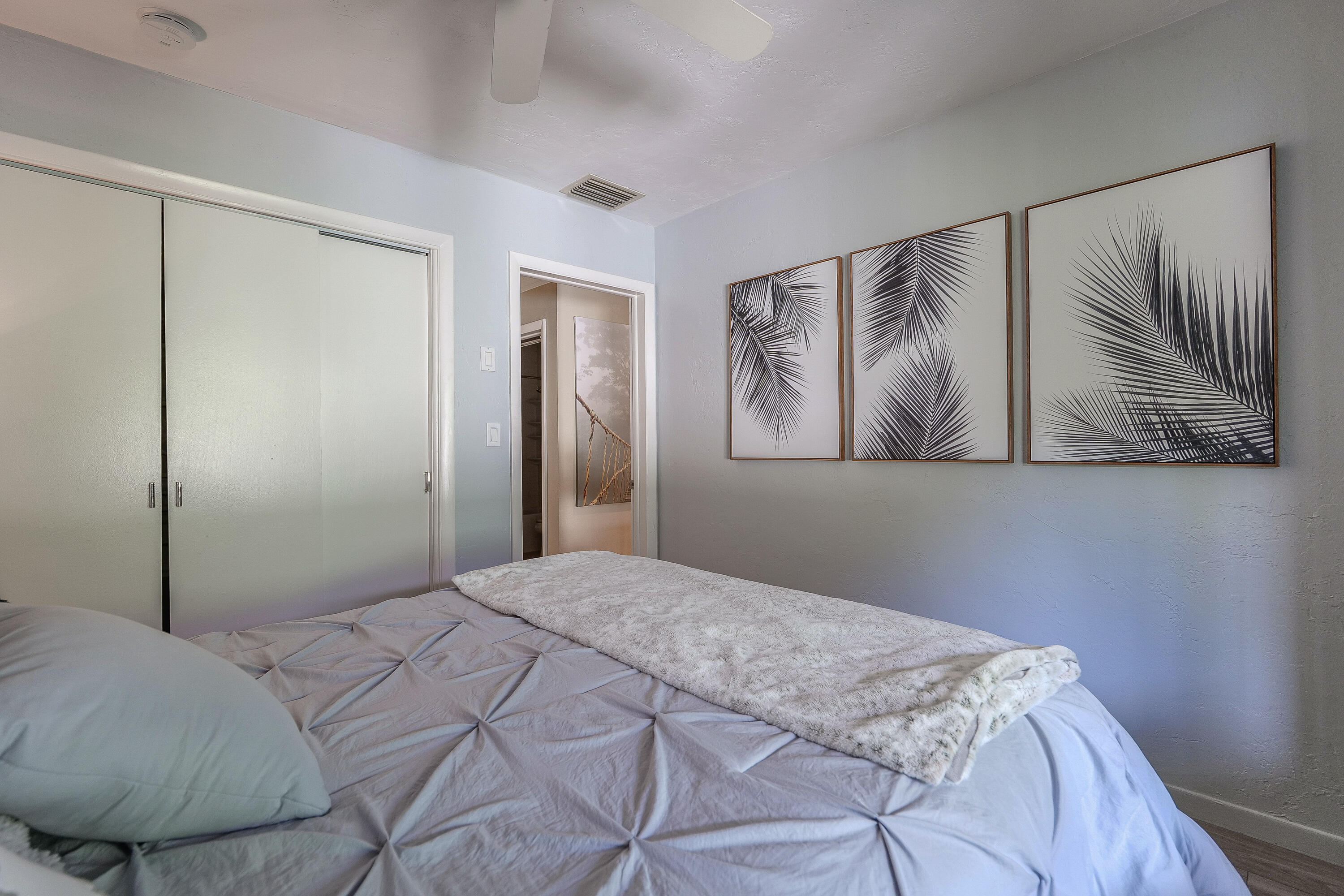 5535 Constant Spring Terrace, Unit 216 Lauderhill, FL 33319 - Photo 16 of 51 a bedroom with a bed and painting on the wall