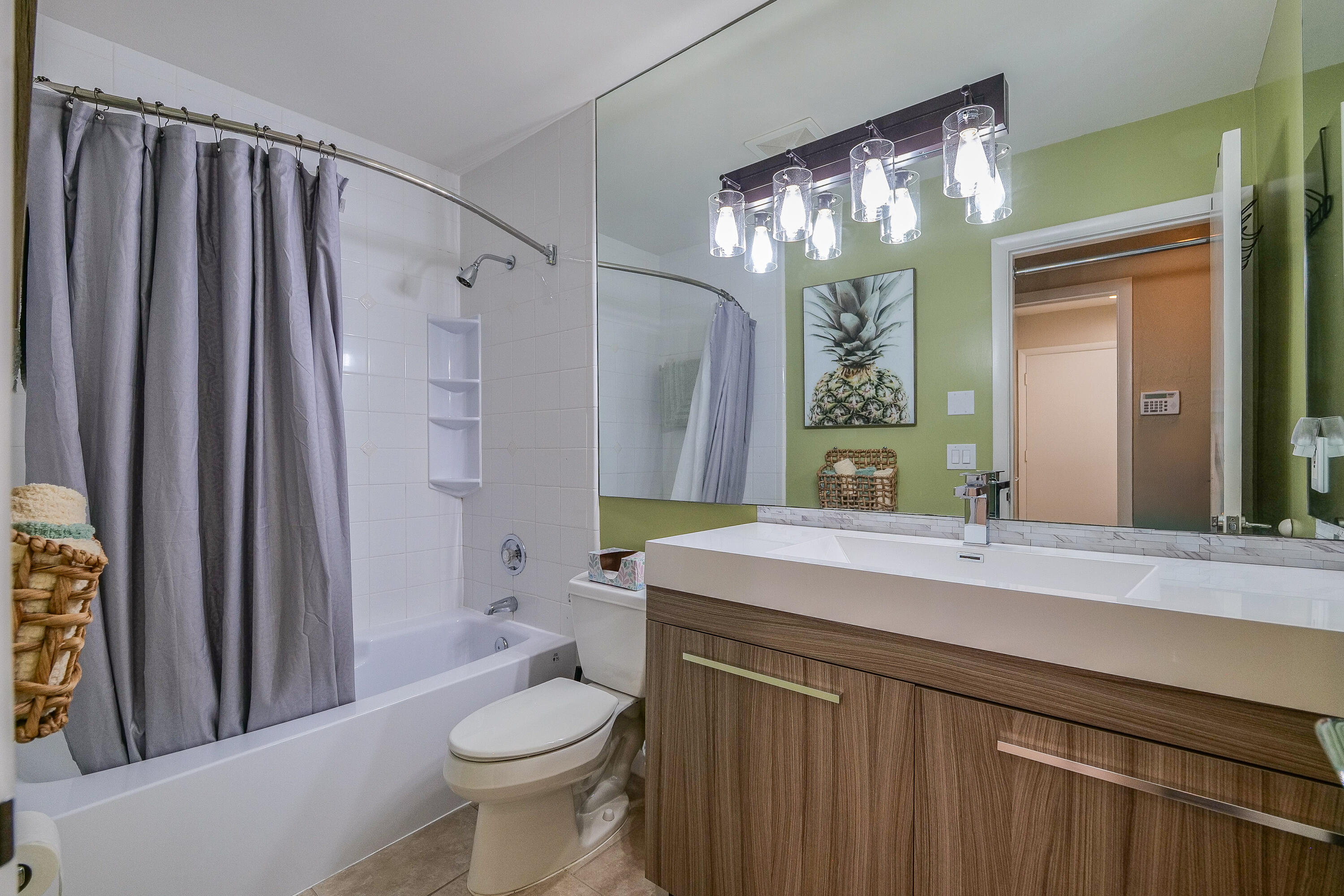 5535 Constant Spring Terrace, Unit 216 Lauderhill, FL 33319 - Photo 17 of 51 a bathroom with a sink a toilet a mirror a vanity and shower