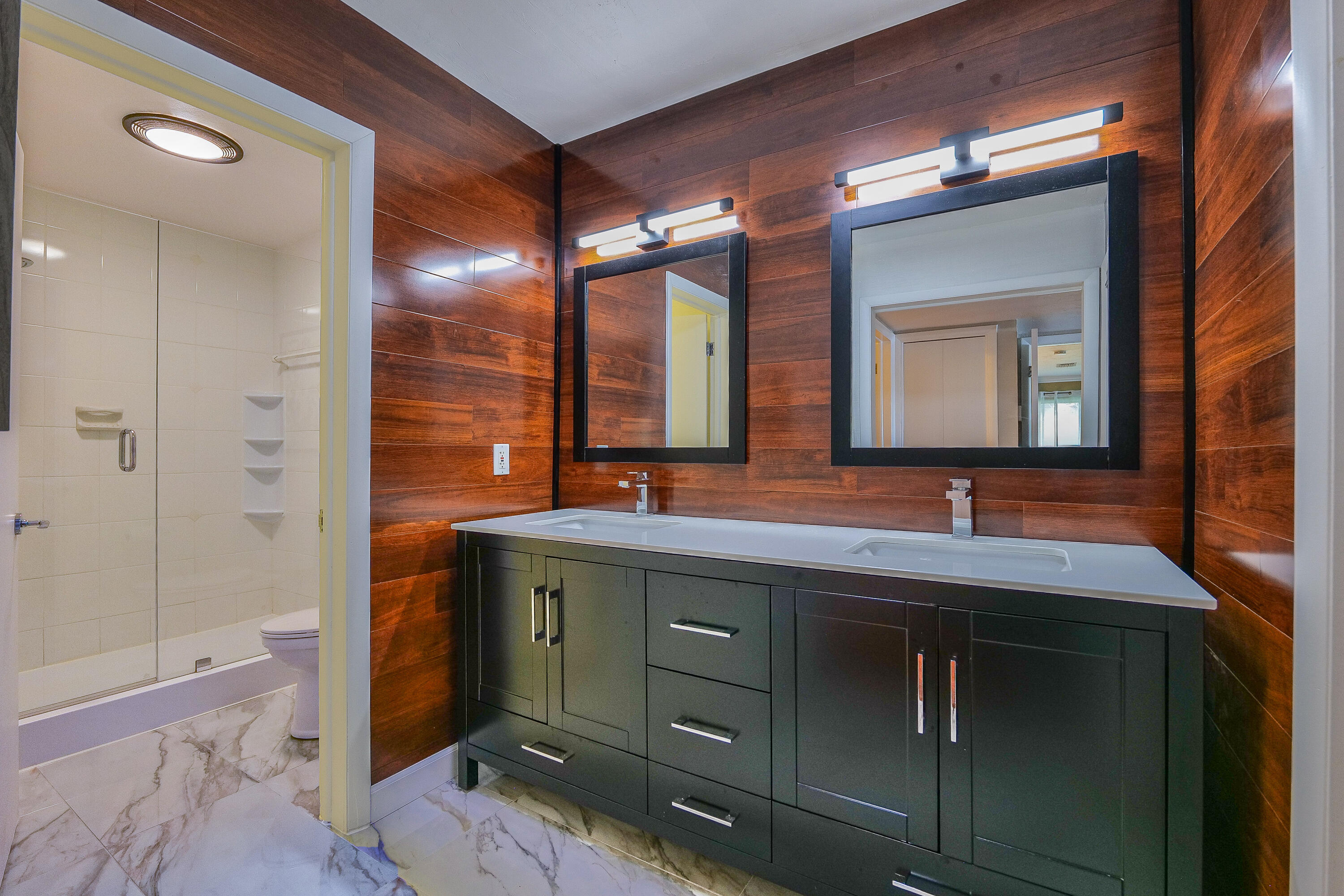 5535 Constant Spring Terrace, Unit 216 Lauderhill, FL 33319 - Photo 26 of 51 a bathroom with a double vanity sink and a mirror
