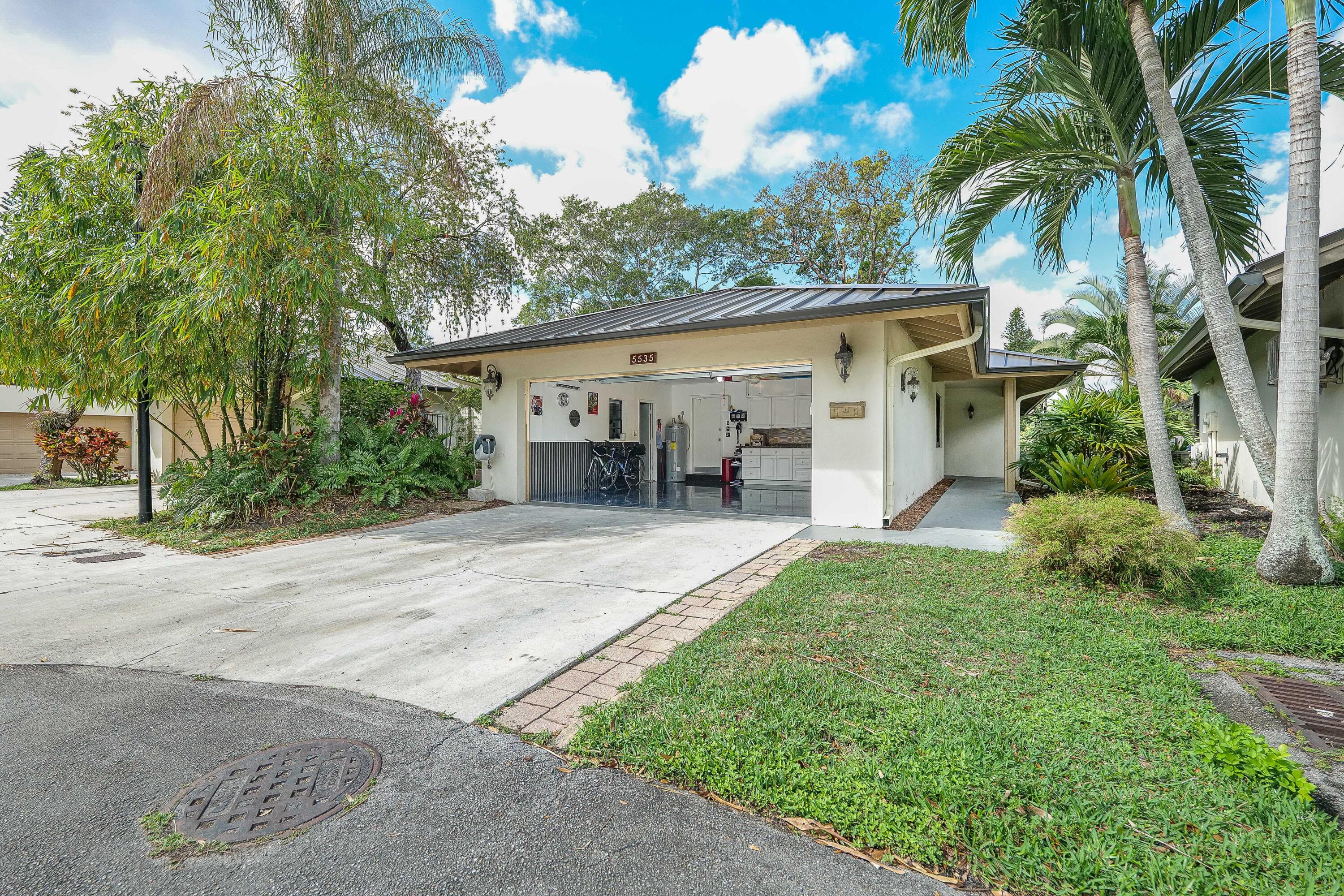 5535 Constant Spring Terrace, Unit 216 Lauderhill, FL 33319 - Photo 32 of 51 a view of a house with backyard and a tree
