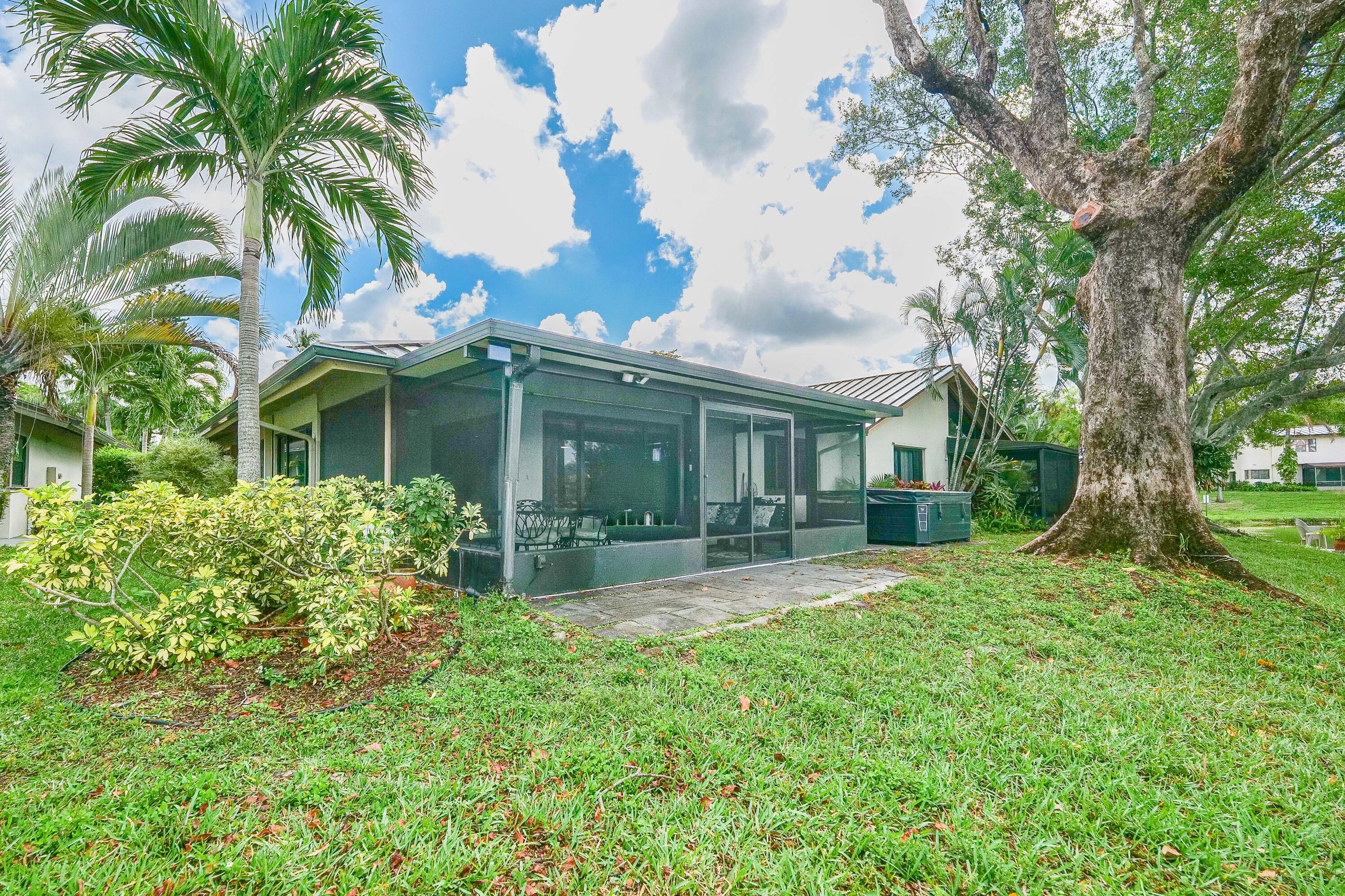 5535 Constant Spring Terrace, Unit 216 Lauderhill, FL 33319 - Photo 37 of 51 a view of a house with a yard and potted plants