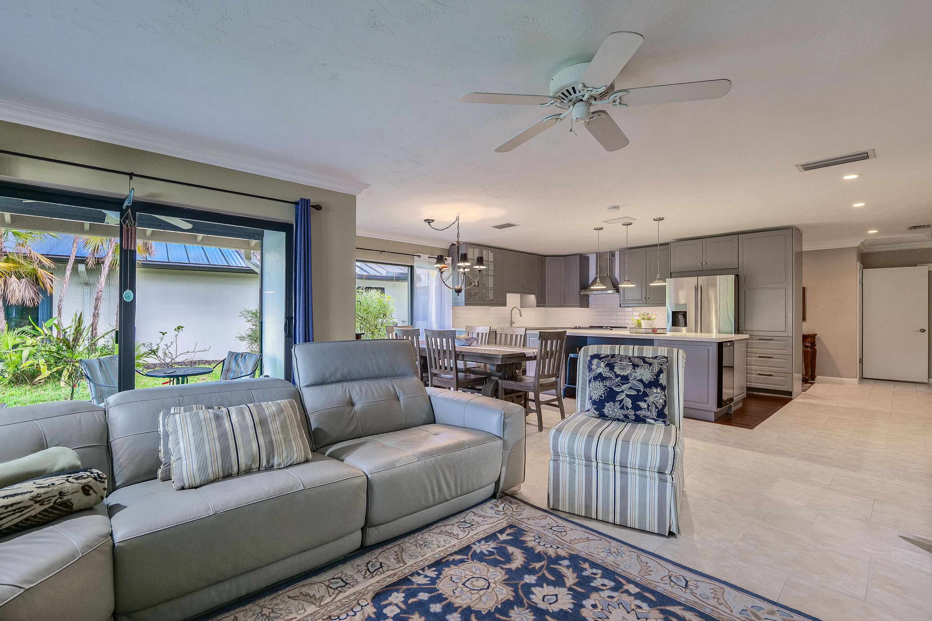 5535 Constant Spring Terrace, Unit 216 Lauderhill, FL 33319 - Photo 6 of 51 a living room with furniture and a chandelier