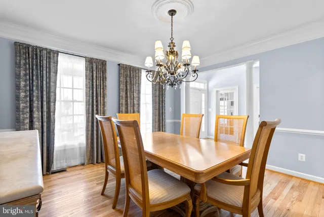 a view of a dining room with furniture wooden floor and chandelier