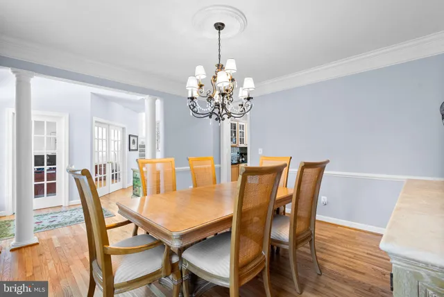 a dining room with furniture and chandelier