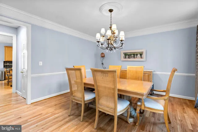 a view of a dining room with furniture wooden floor and a chandelier