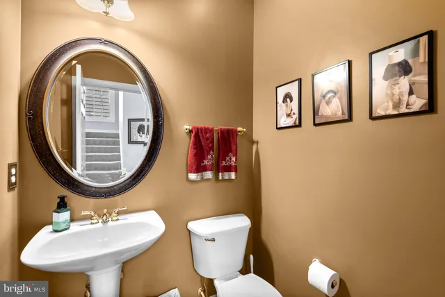 a bathroom with a toilet a sink and a mirror