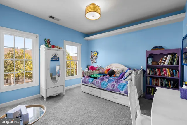 a bedroom with furniture and a window