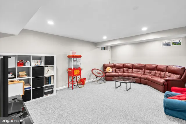 a living room with furniture a air conditioner and a window