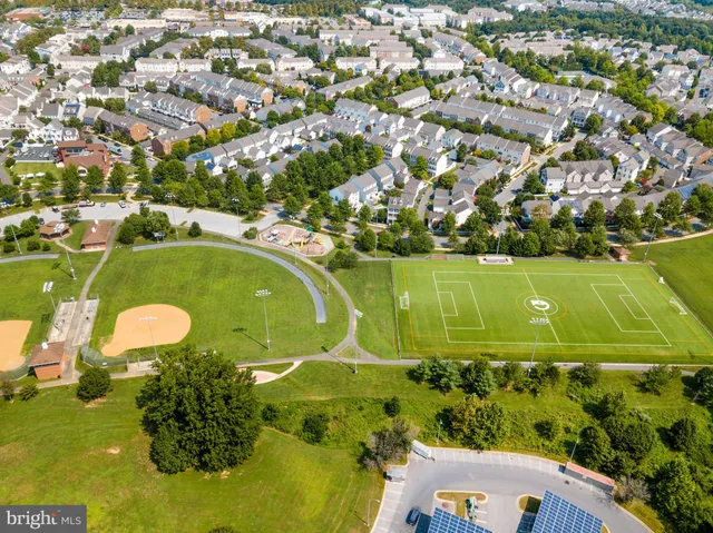 an aerial view of a residential houses with outdoor space and swimming pool