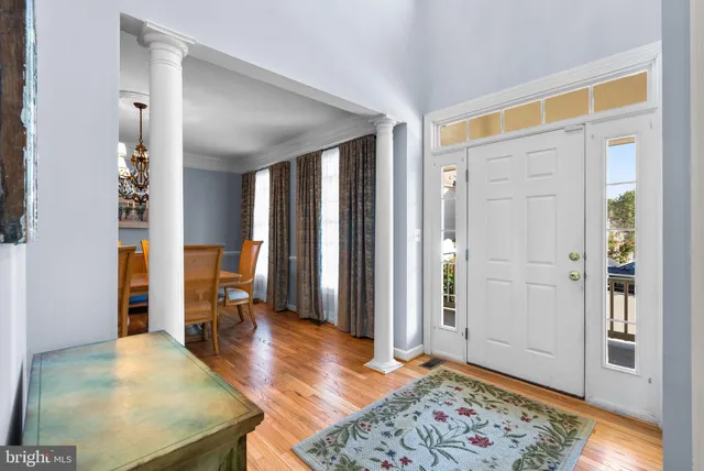 a view of a hallway with wooden floor and furniture