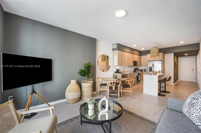 a living room with furniture a rug and a flat screen tv