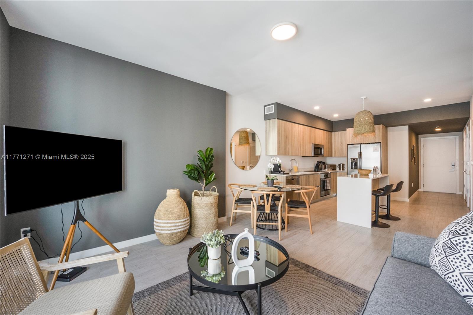 3900 Biscayne Boulevard, Unit S1016 Miami, FL 33137 - Photo 7 of 12 a living room with furniture a rug and a flat screen tv