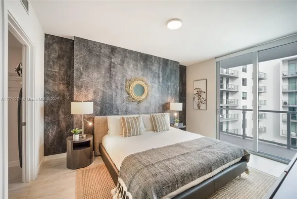 a bedroom with a large bed and a large window