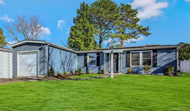 a view of a backyard with table and chairs and a large tree