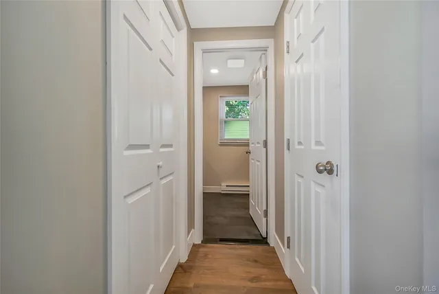 a view of a hallway with a wooden door