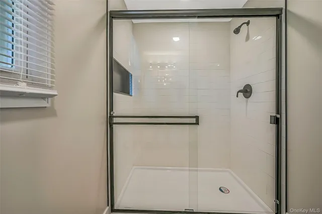 a bathroom with a glass shower door