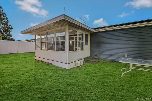 a view of a house with a backyard