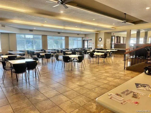 a living room with couches a dining table and kitchen view