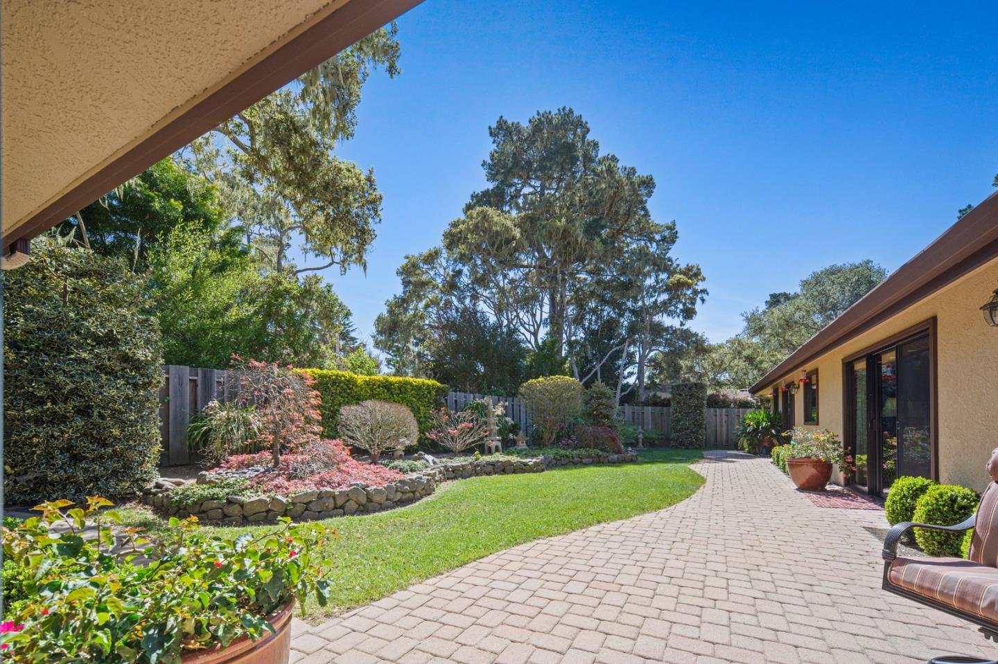 2911 Colton Road Pebble Beach, CA 93953 - Photo 40 of 46 a front view of a house with a yard and fountain