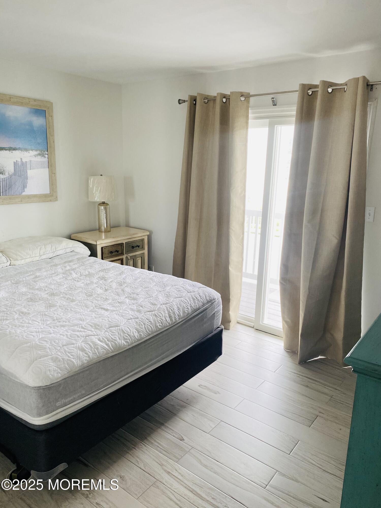 1 2nd Avenue, Unit 34 Seaside Heights, NJ 08751 - Photo 11 of 19 a bedroom with a bed and a window