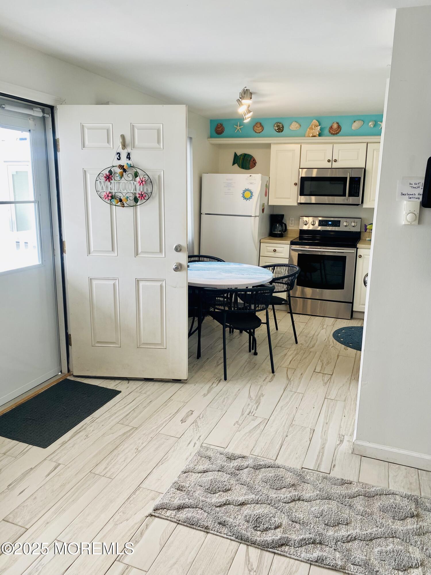 1 2nd Avenue, Unit 34 Seaside Heights, NJ 08751 - Photo 13 of 19 a living room with furniture and a wooden floor