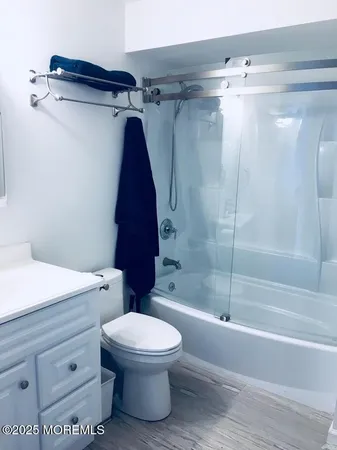 a bathroom with a toilet and a shower